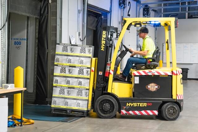 man-riding-a-yellow-forklift-with-boxes-1267324